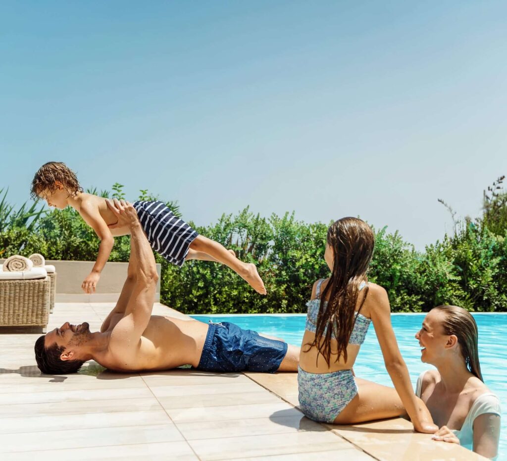 Family playing beside the pool