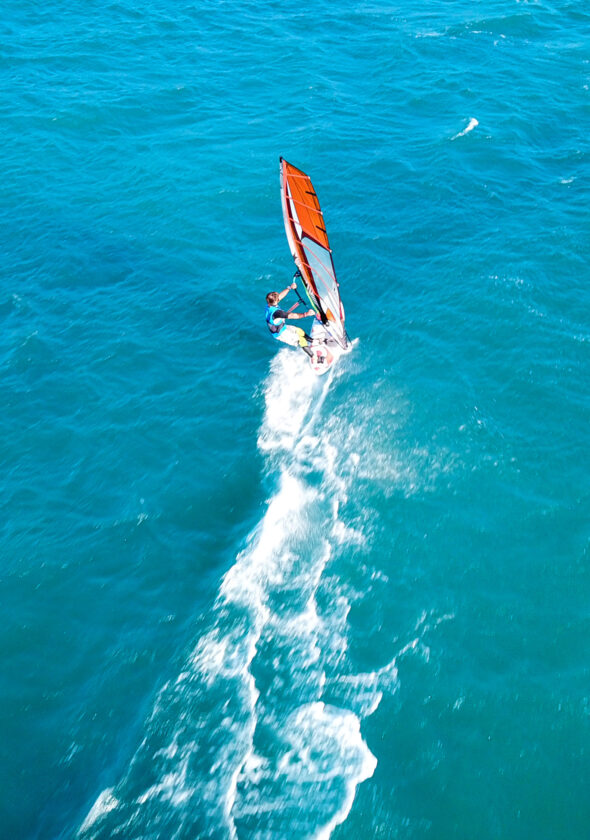 aerialdronephotoofsurfercruisinginhighspeedin