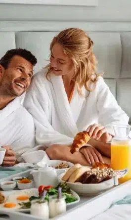 Couple eating breakfast in bed