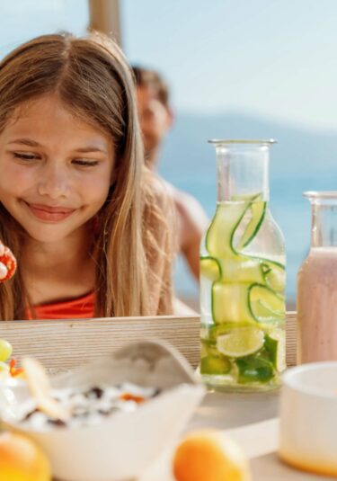 Ikos Resorts _ Girl enjoying beach service_2880x1920 (1)